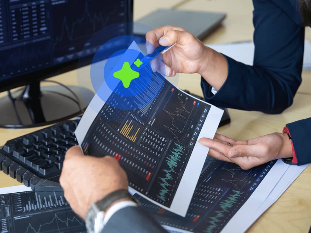 Person holding tablet displaying financial graphs and data.