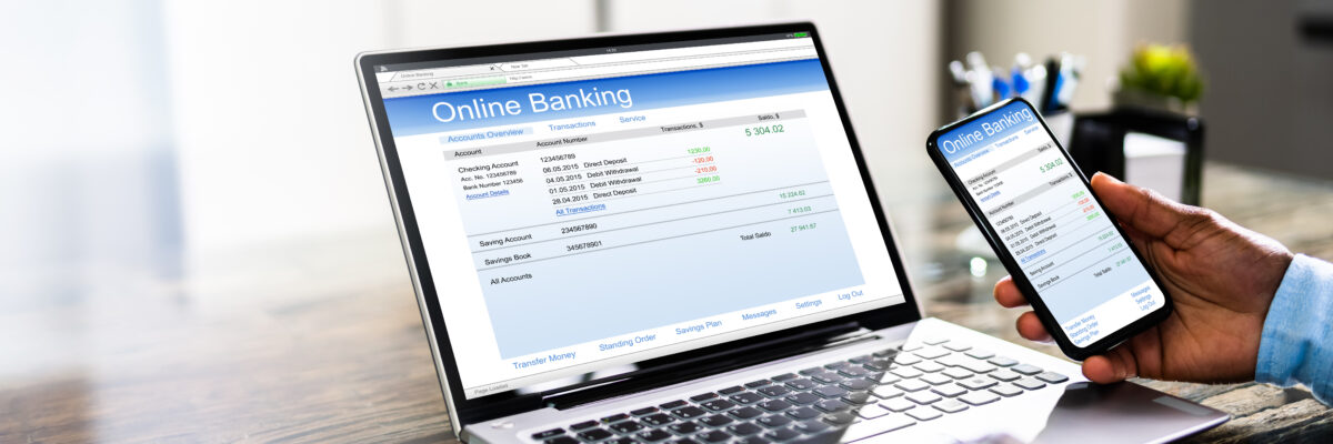 Person using online banking on laptop and smartphone.